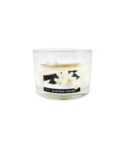 Vanilla scented candle in shallow clear glass jar